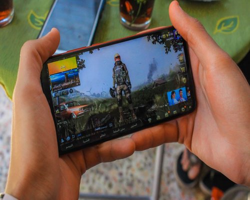 Angled smartphone showing the fictional Coral Colour Chamber exploration game