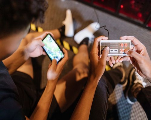 Angled smartphone showing the fictional Pixel Formula Run arcade game